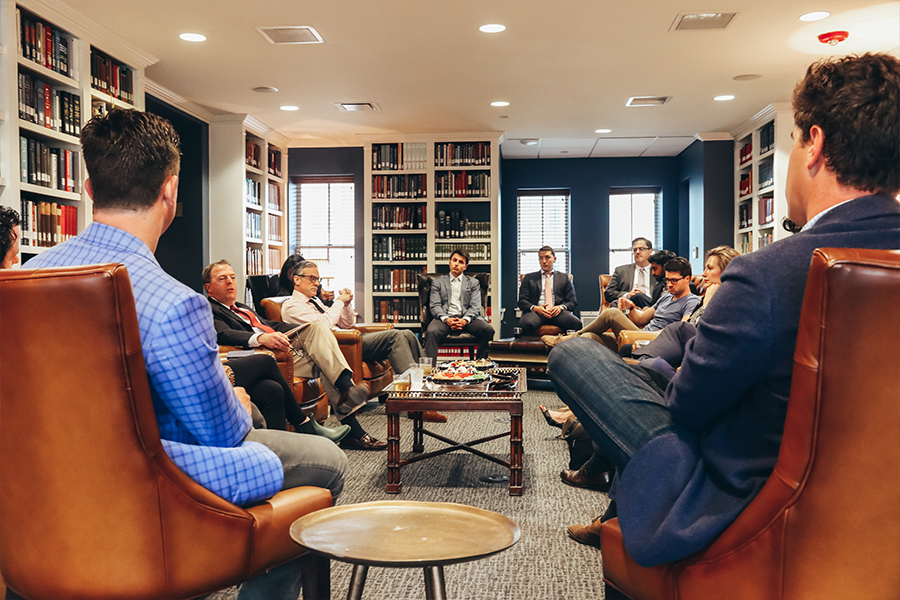 Several Kirby Center event participants conversing with Dr. Larry Arnn.