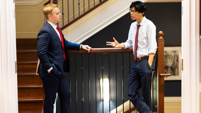 Alumni conversing in front of the White House.